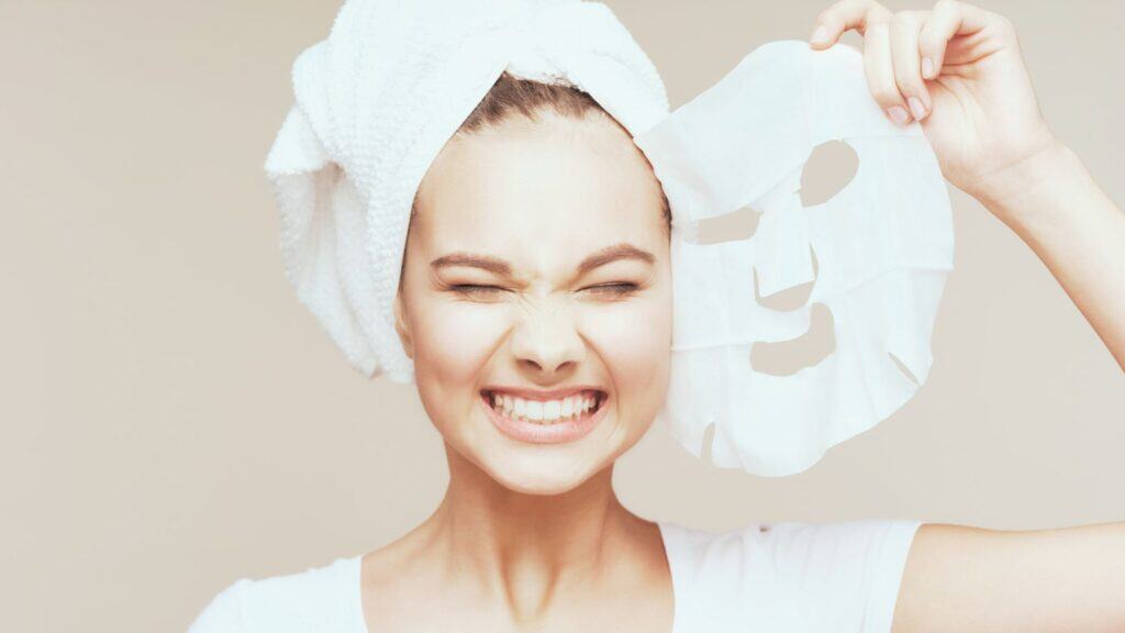 Young girl using sheet face mask
